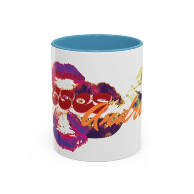 The Kiss Print Accent Coffee Mug — Personalized 'A Thousand Kisses' Pop-Art Lip Design (11oz) features a white ceramic exterior, blue interior, vibrant lipstick prints, and bold lettering. It's dishwasher-safe and perfect for everyday style.