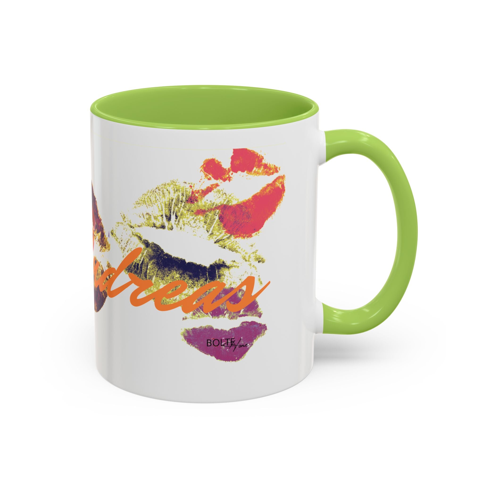 Mug with colorful design and green handle on a white background