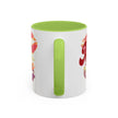 White mug with green interior and handle, featuring colorful fruit illustrations on a white background