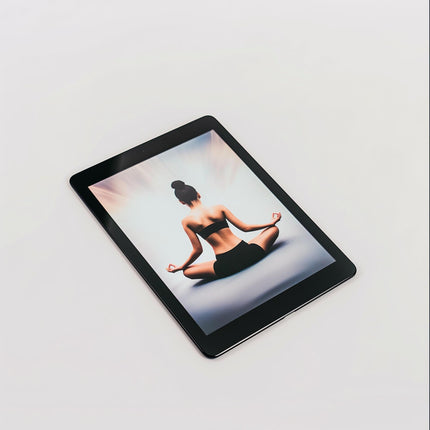 An Example product tablet rests on a white surface, showing a woman in workout clothes sitting cross-legged in a meditative yoga pose with her hands on her knees, viewed from behind.